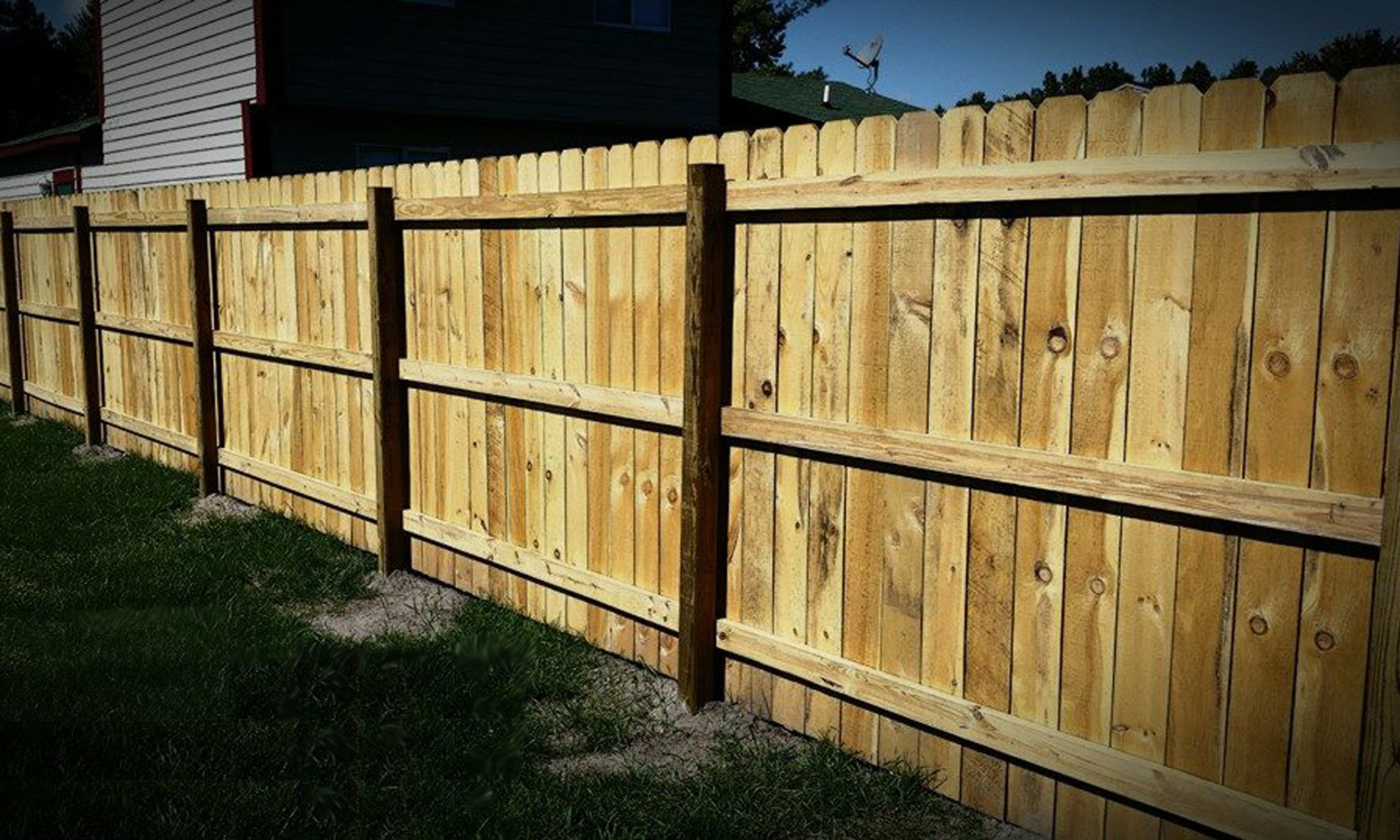 Pressure treated wood privacy fence